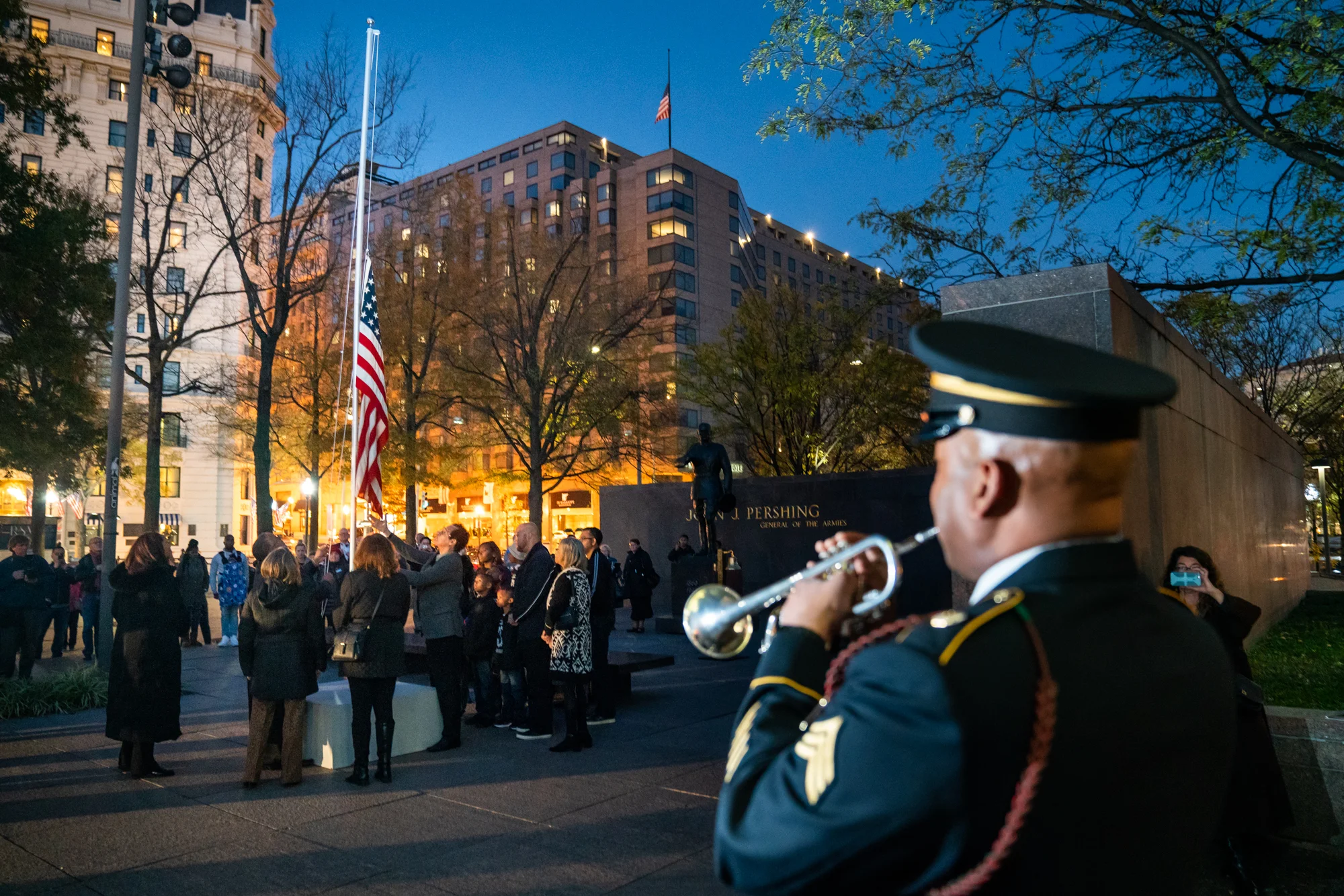 To conclude the evening, guests lowers the American flag as the 369th Experience Band director, Dr. Isrea Butler, performs Taps.