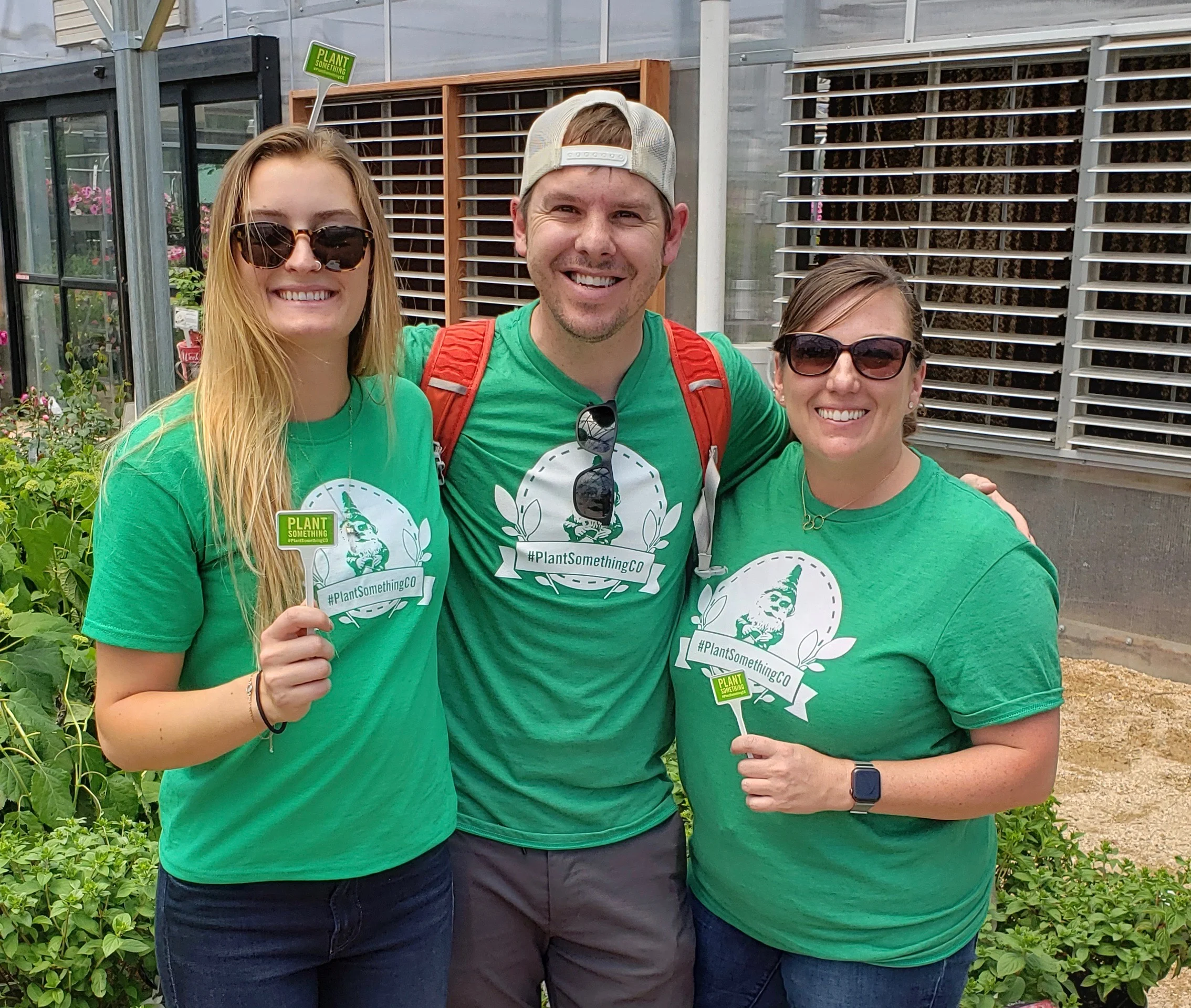 Katie, Ben, and Allison hold up their official #PlantSomethingCO stakes after the live event
