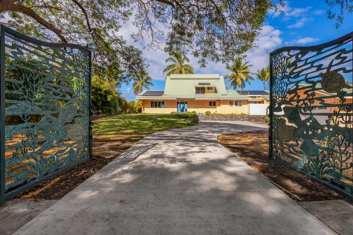 Artistic custom gates open to this home set directly on scenic – and historic – Kealakekua Bay in South Kona.