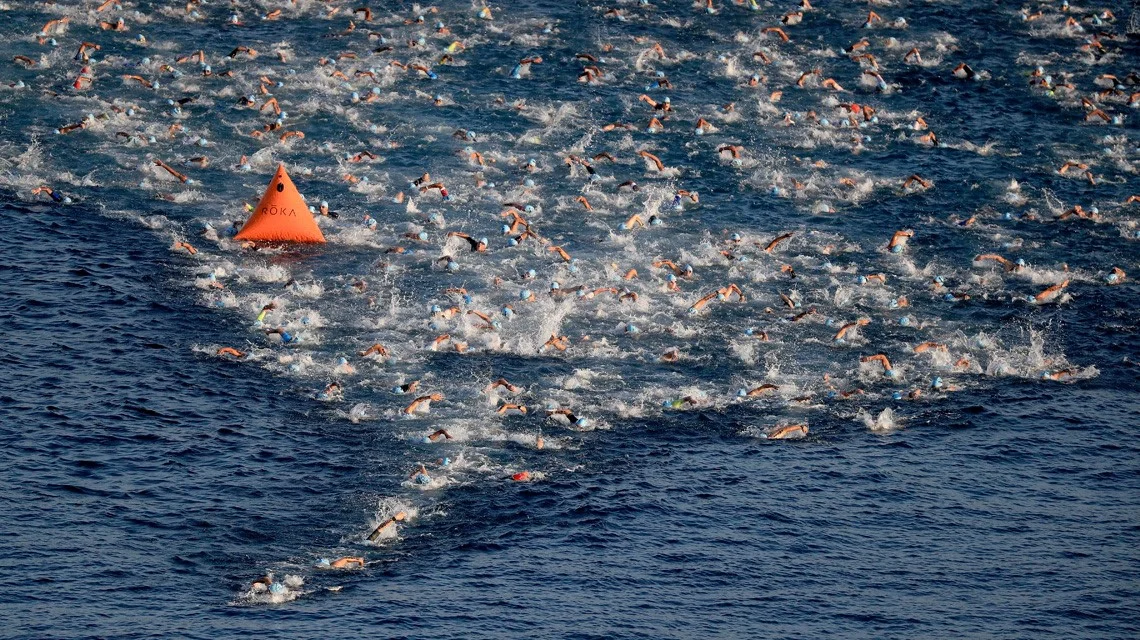 Athletes round the ½ way buoy on the Ironman World Championship course in Kailua-Kona Bay. Photo by Sean M. Haffey/Getty Images for IRONMAN.