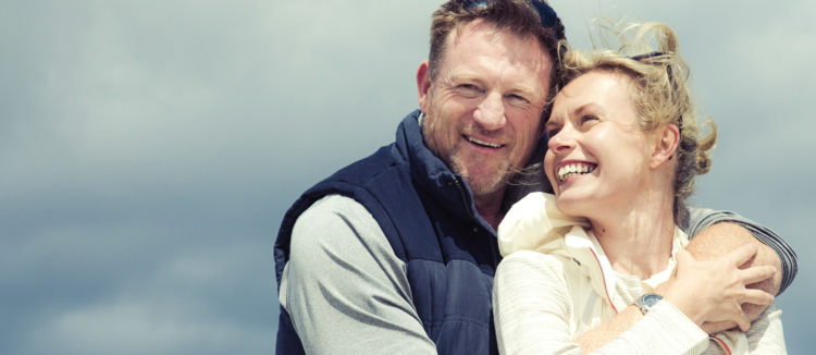 older-couple-with-dental-onlays-hug-outside.jpg