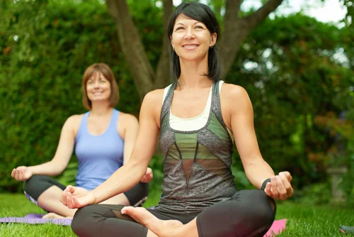 A woman doing yoga who is happy with her smile. 