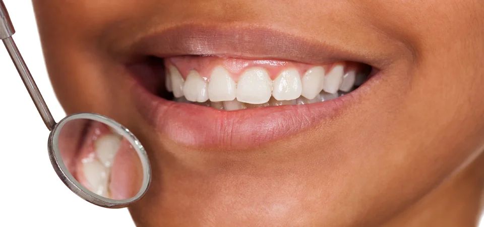 A young kid smiles in the dentist chair