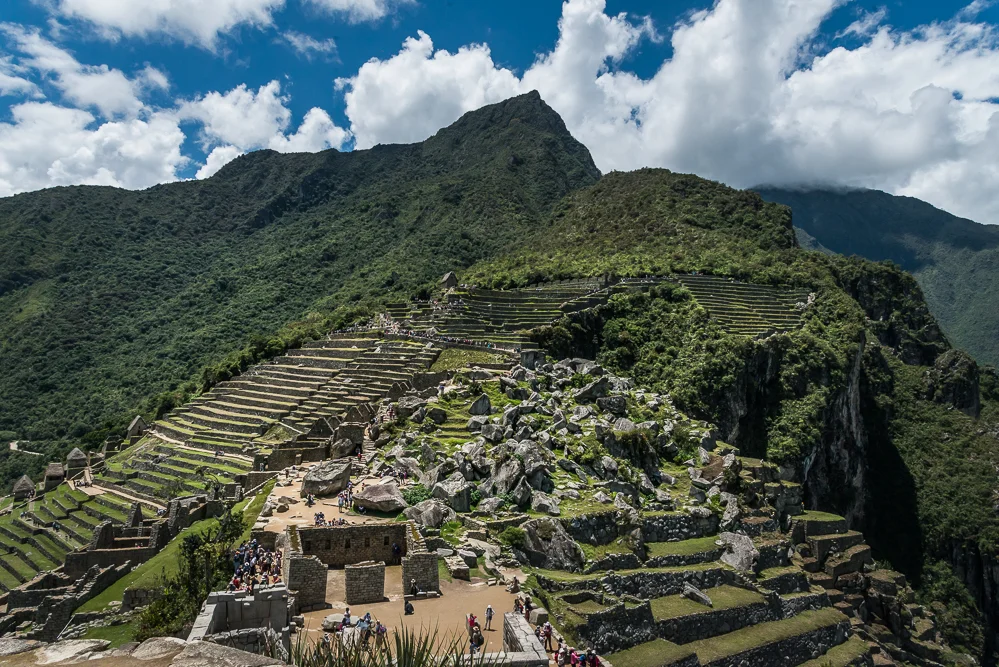 Machu Picchu, seen from the higher level of the Sacred Plaza, near the Intihuana stone. In the foreground, we see the Main Temple, below, and the upper section of the Urban Sector. To the left, we see the terraces of the Agricultural Sector, and in the center, in the distance, we see the Watchman's Hut, from where I had taken panoramic views earlier in the morning.