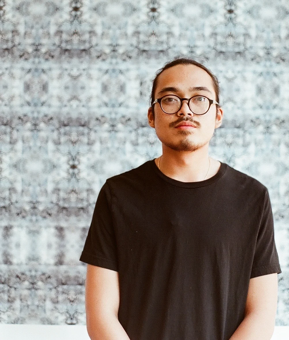 Ricky Orng is a Cambodian-American communications designer and practicing artist. Ricky Orng is a photographer, spoken word poet, and accomplished teacher. He has worked extensively with youth organizations such as IBA, URBANO Project, and Castle Square on contemporary arts and social justice projects. He currently eats ramen at the arts community space, EMW Bookstore, and serves as the Director of Lowell's Youth Spoken Word organization, FreeVerse!. Orng hosted the first Asian American & Pacific Islander Poetry Reading at the National Poetry Slam in Boston in 2013. He currently organizes a bi-monthly open mic in Lowell, MA. Orng has taught and facilitated many spoken word poetry workshops and readings across North America including New York City Asian American Student Conference, URBAN WORD Preemptive Education Conference, and Massachusetts Poetry Festival. His works have been featured on Angry Asian Man , Absolutely Fobulous , Lowell's Artist Anthology , Young Angel Midnight ; and Cambodia's first bi-lingual fashion publication, F-Magazine , and HYPEBEAST . Orng aims to share his works and teaching in order to give tools and strength to disempowered and marginalized voices.