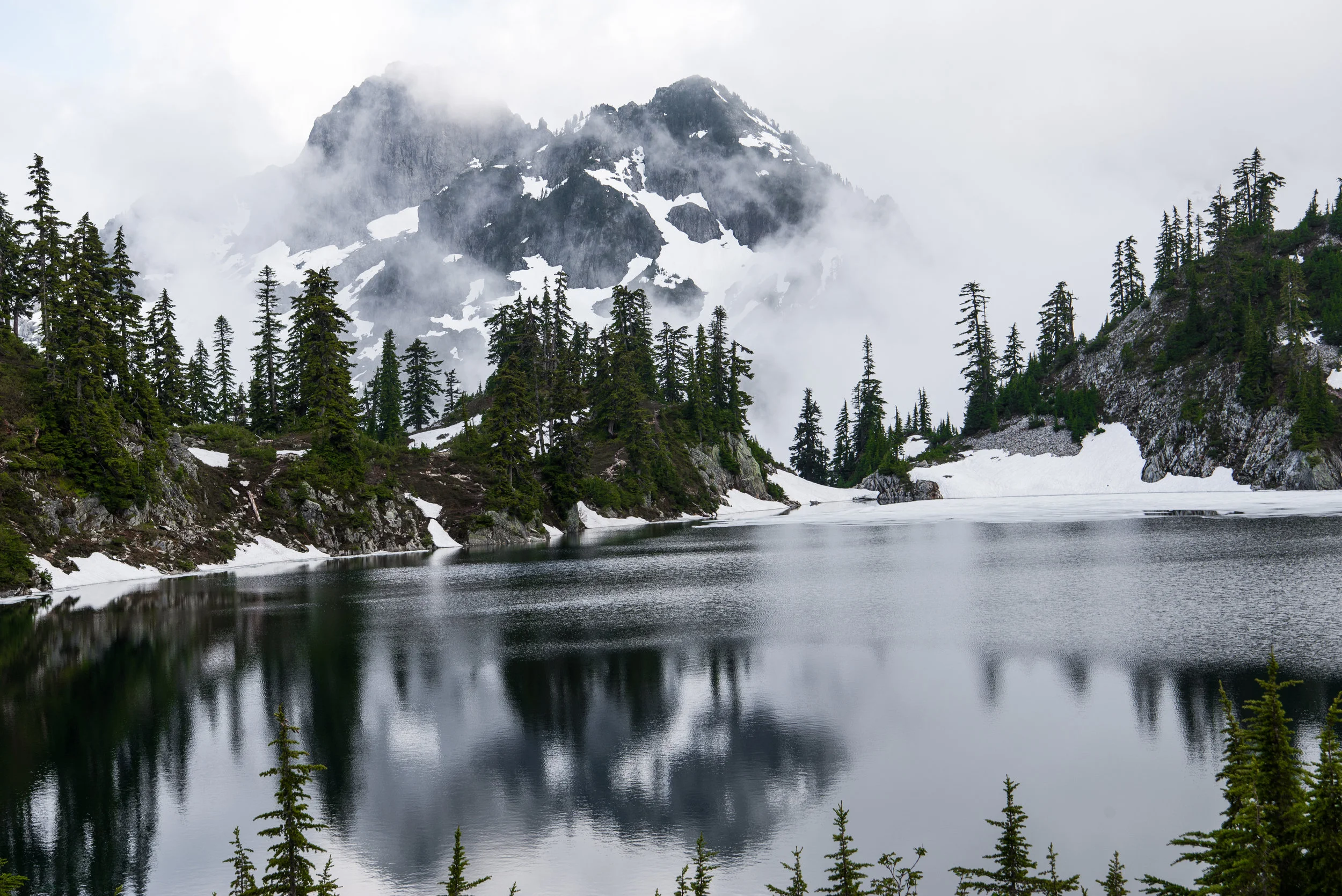 Chair Peak peaking out through the clouds.