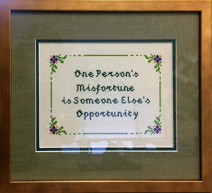 Cross-stitch quote. Quote by Donald Trump from the Real Estate Goldmine seminar. Cross-stitch by Melissa Estro. Framing by Kat Starcher.