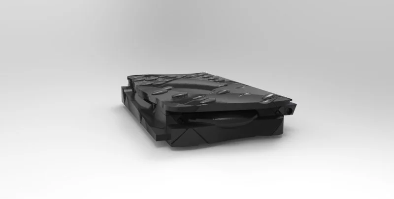 A black plastic tray with multiple compartments, possibly an organizer or storage container, placed on a plain white background.