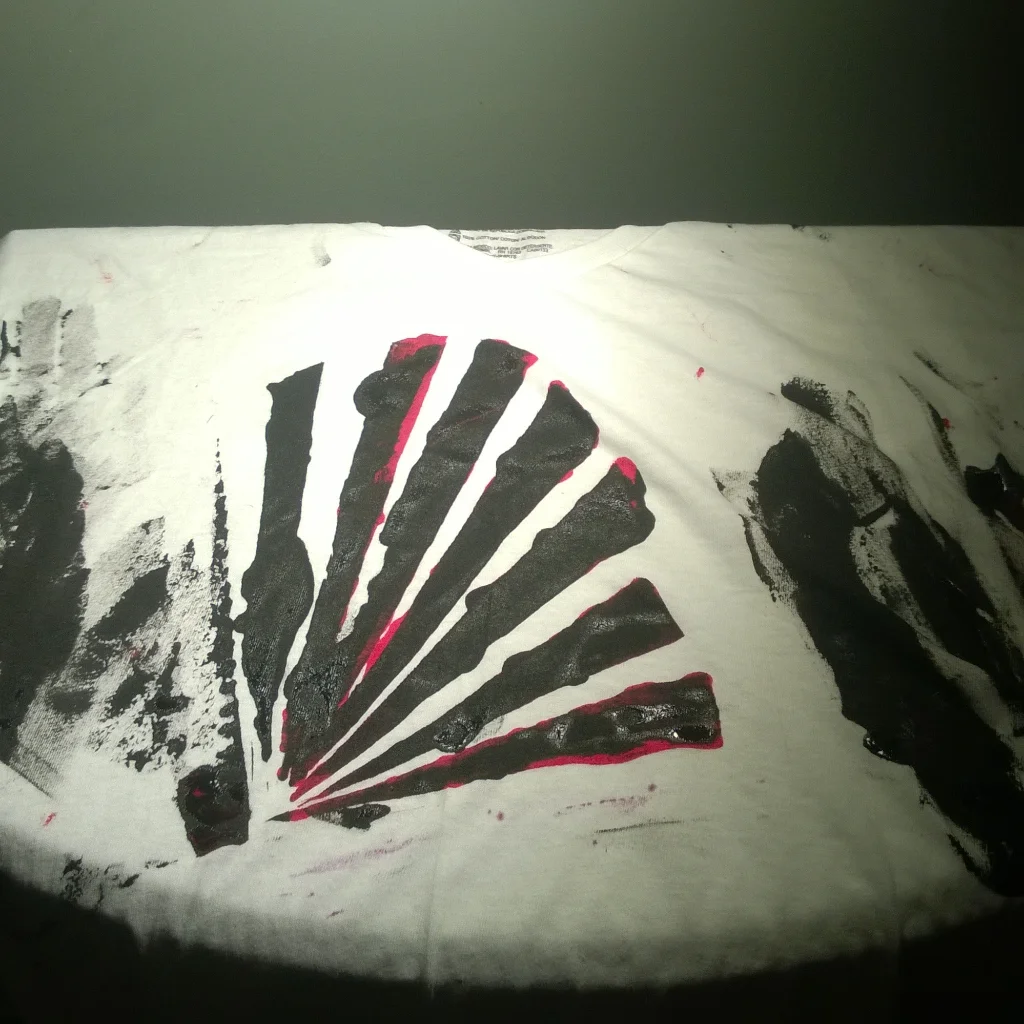 Abstract black and red painted design on a crumpled white surface with a gray background.