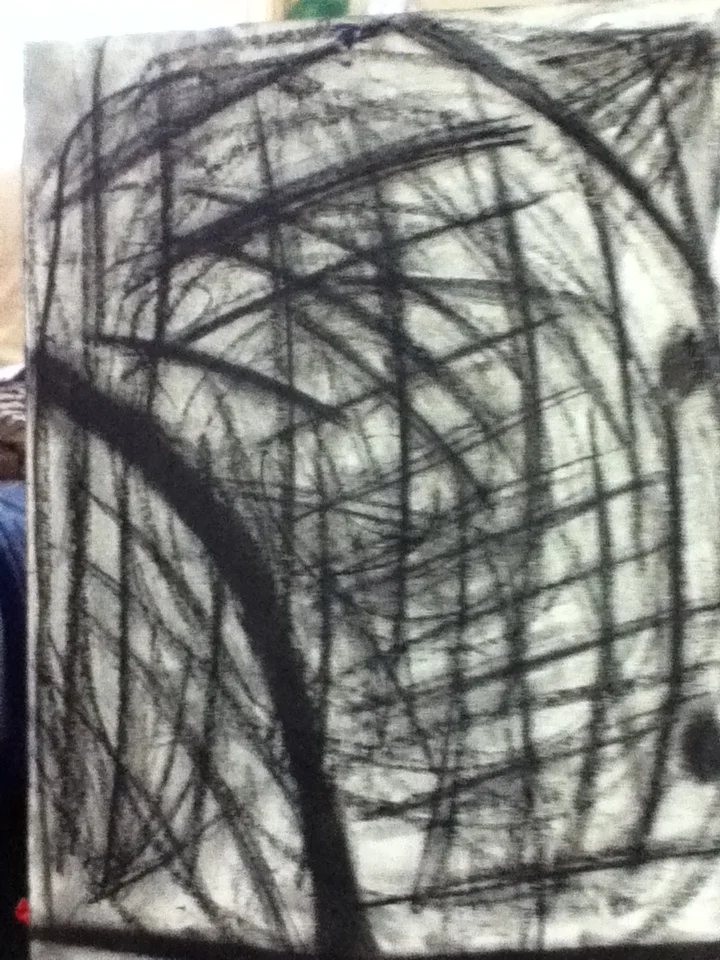 Abstract black crayon scribbles on white paper with overlapping lines and curved shapes.