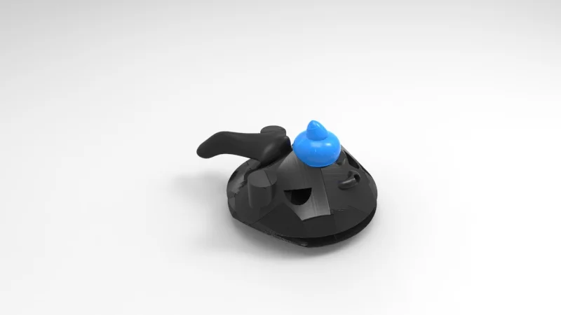 A black and gray plastic toy with a blue accessory on top, resembling a stylized animal face with a smiling mouth, set against a plain white background.