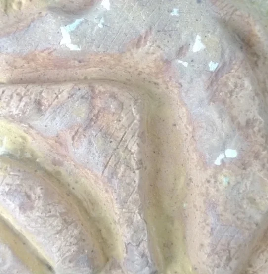 Close-up of a partially eaten cupcake with creamy frosting and sprinkles.