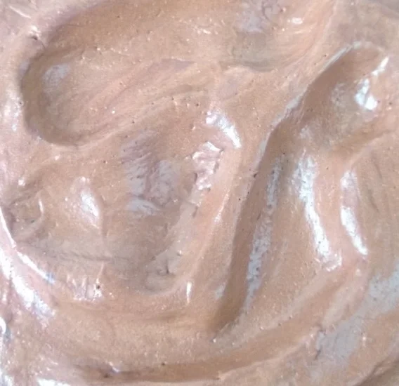 Close-up of a creamy, brown, possibly chocolate-flavored ice cream or mousse.