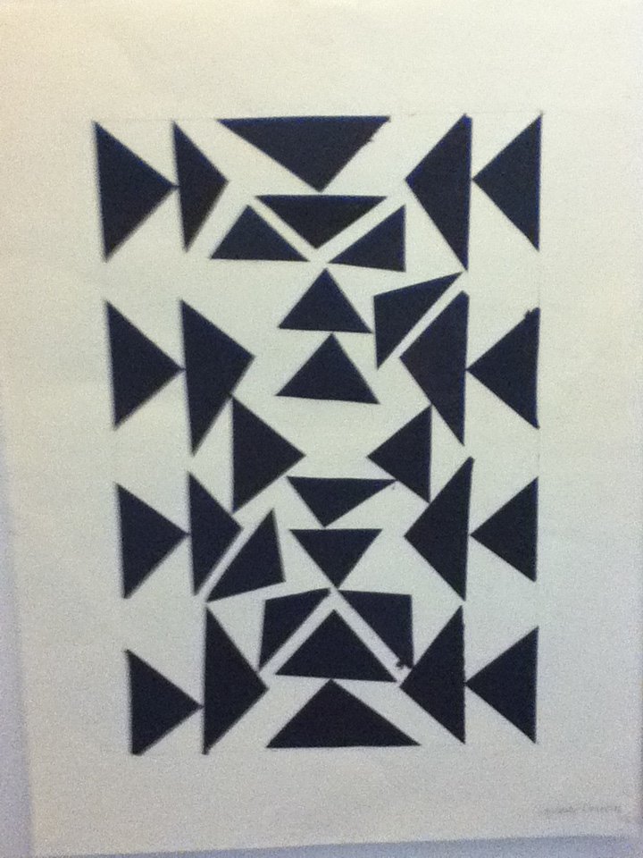 Abstract geometric art composed of black triangles and shapes on a white background.