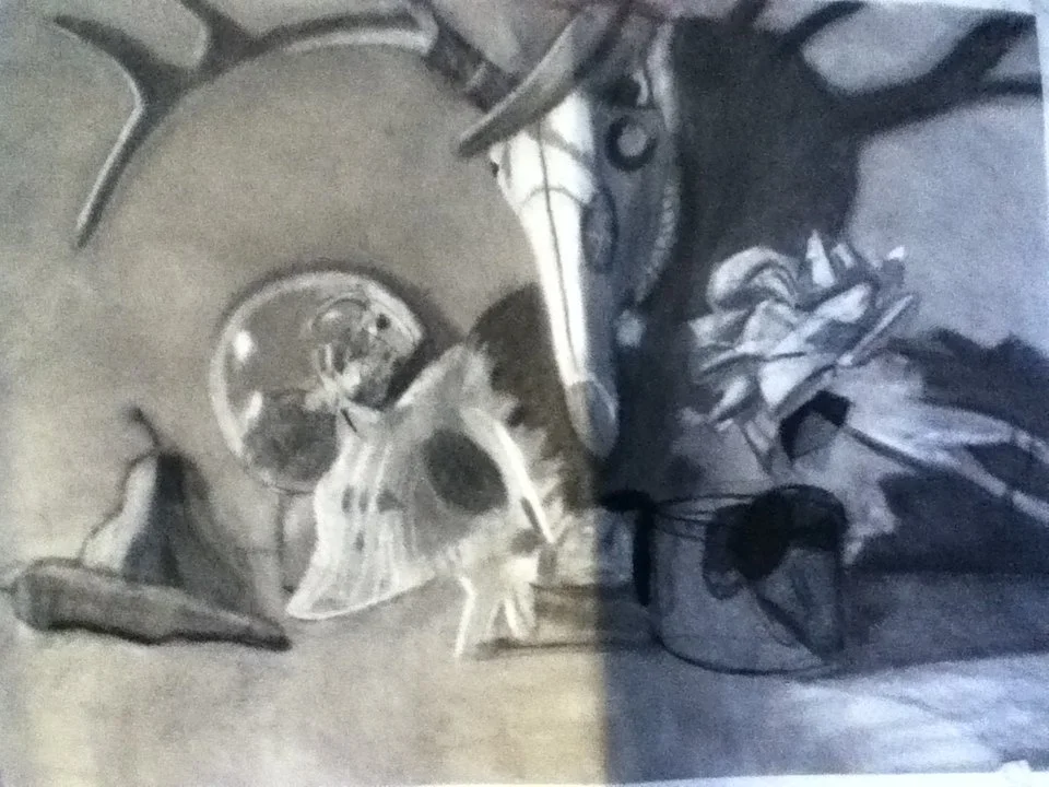 A pair of sunglasses, a notebook, a pen, a butterfly, and some other objects on a desk or table.