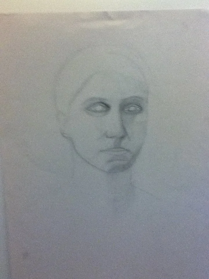 A pencil sketch of a child's face with a serious expression, missing eyes and facial details, on a white sheet of paper.