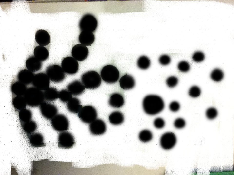 Black circular objects of varying sizes arranged on a white background.