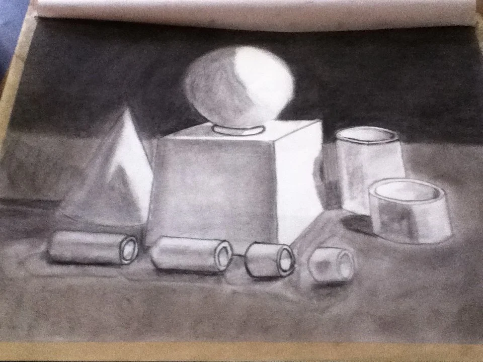 A still life drawing of various geometric shapes and objects, including a pyramid, a sphere on a pedestal, a rectangular prism, and several cans and bowls, rendered in black and white.
