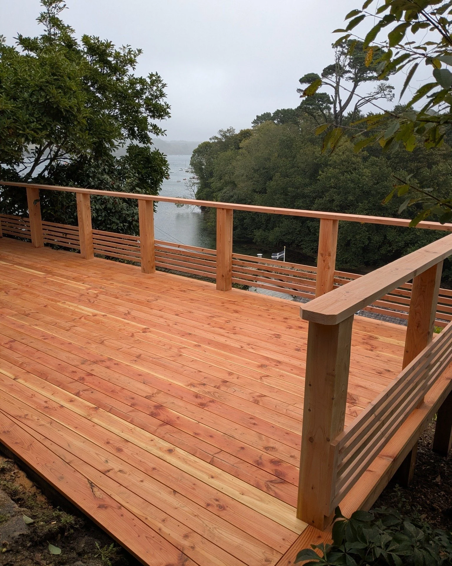 Replacing a raised deck that makes use of a sloped garden in Helford and means that the clients can sit and enjoy that incredible view. Constructed using locally sourced Douglas Fir.

Steve is currently finishing up the project by replacing a few pav