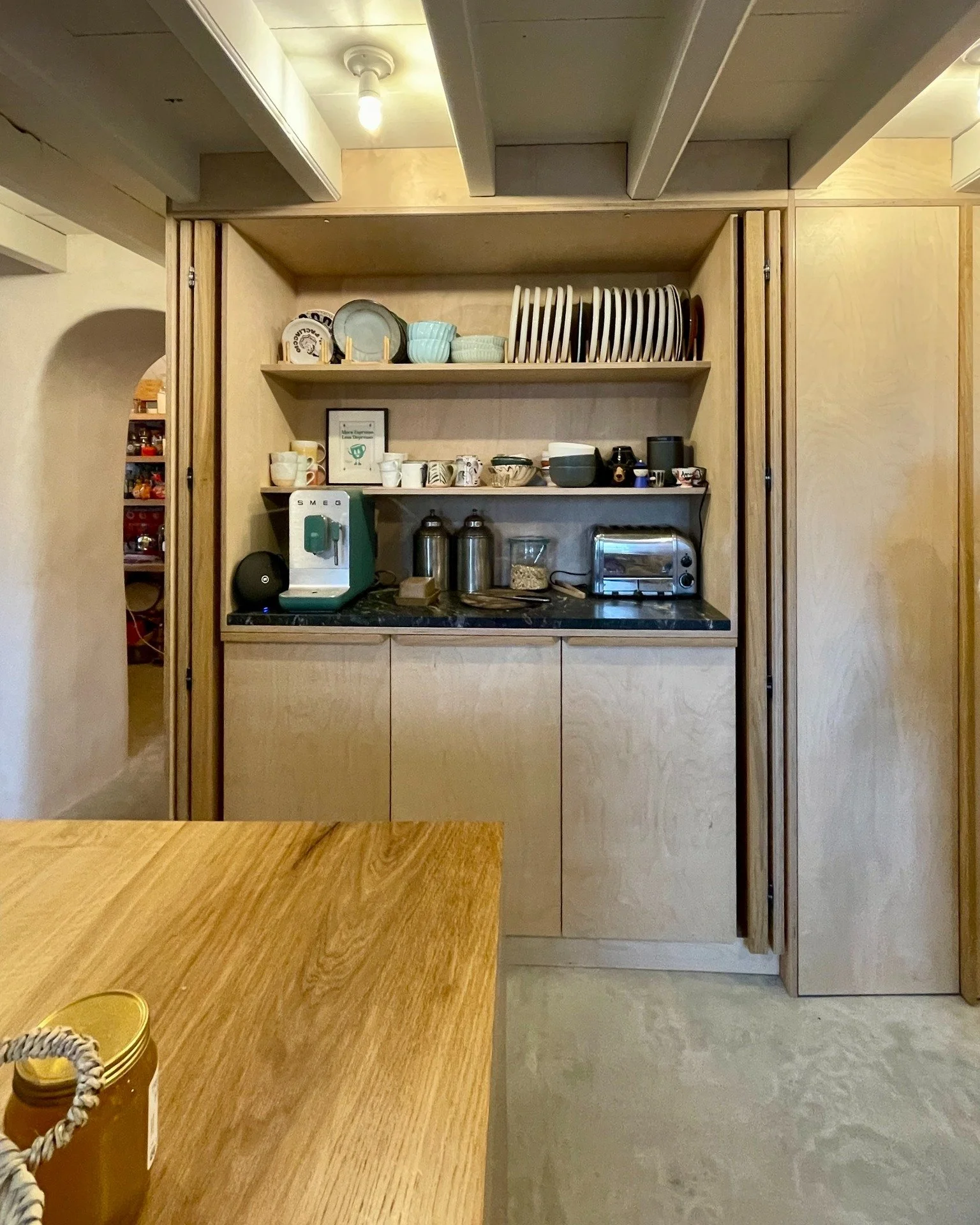 Custom kitchen crafted from birch plywood cabinets, complemented by oak drawers, doors, and countertops &mdash; all set in a beautifully refurbished Cornish farmhouse. This project seamlessly blends practicality with a design-forward aesthetic, creat