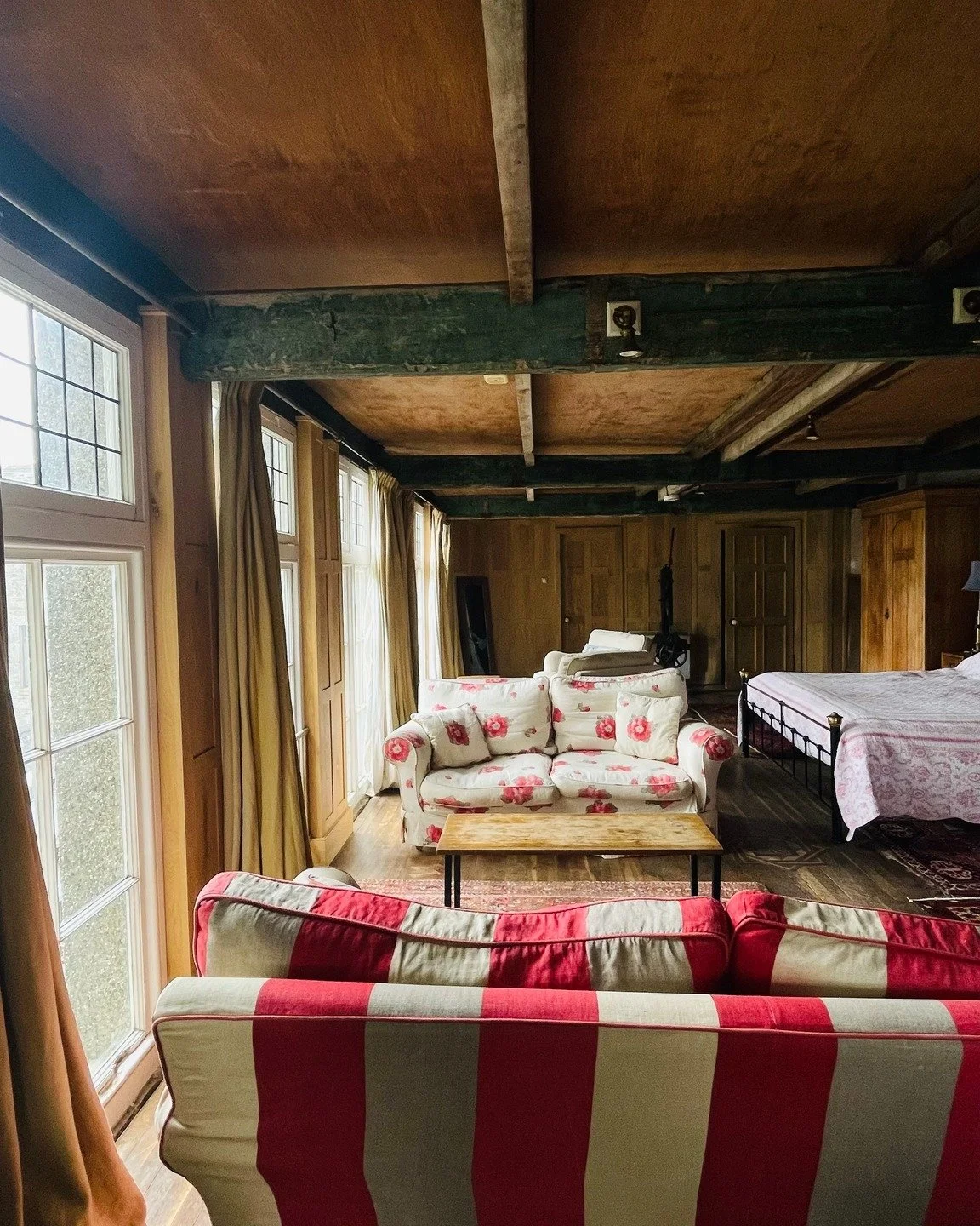 Crafted in solid oak to complement the original interiors of The Workshop at Porth-en-Alls, the panelling wraps seamlessly around the room, with matching doors and antique hardware.

These photos capture it as intended &mdash; furniture back in place