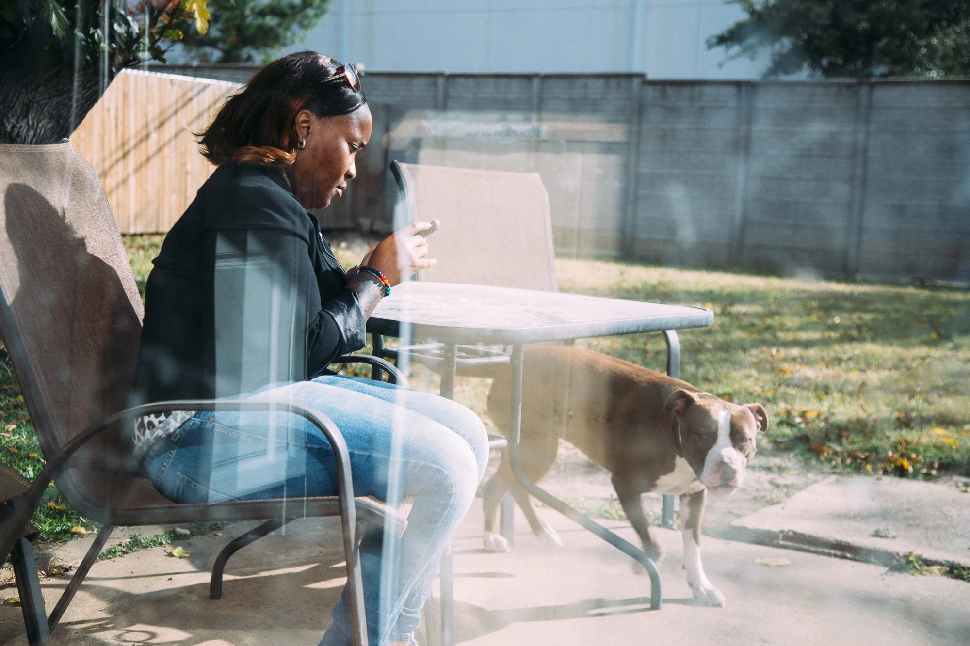 Katrina sits outside with her two pitballs.