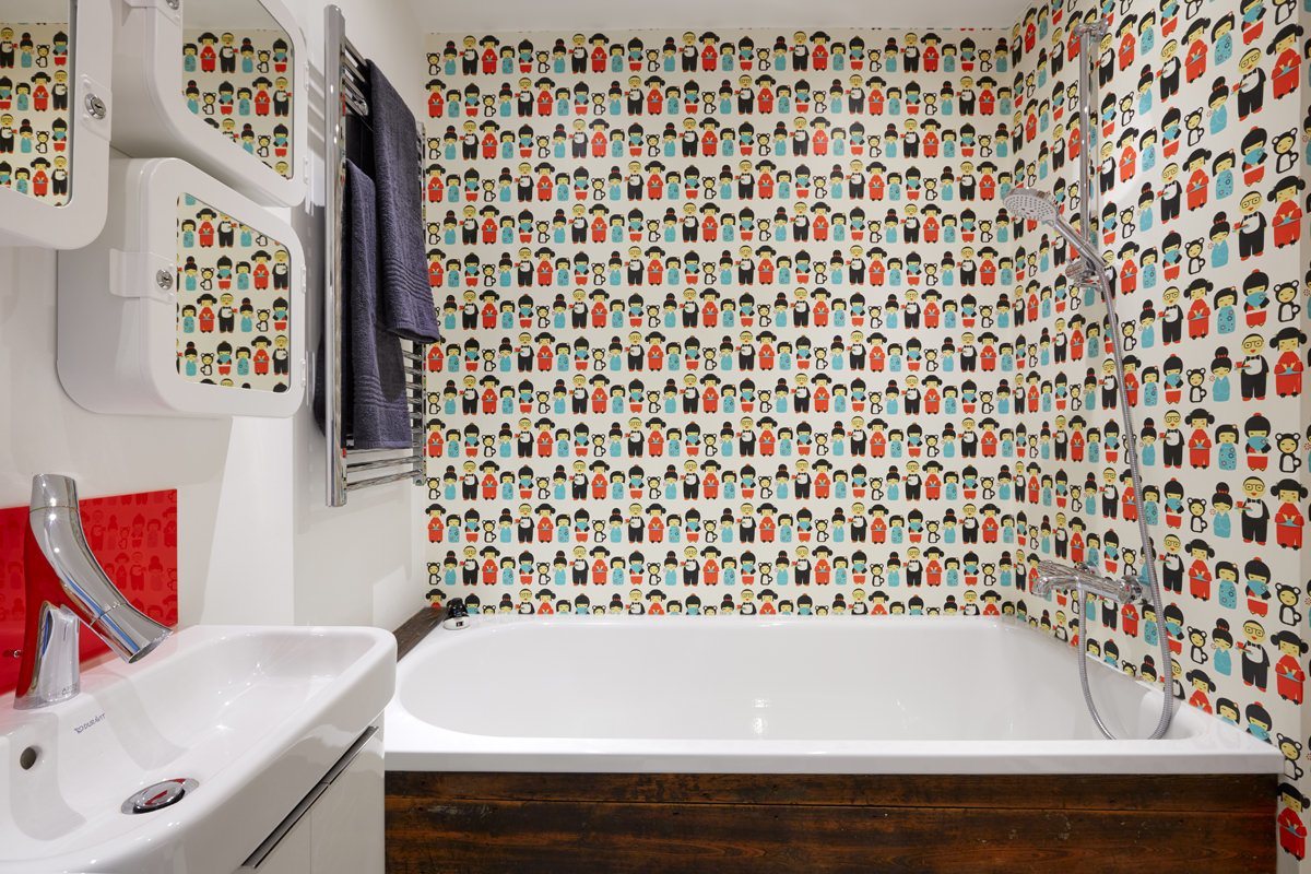 Varnished wallpaper makes a fun alternative to the traditional tile. 