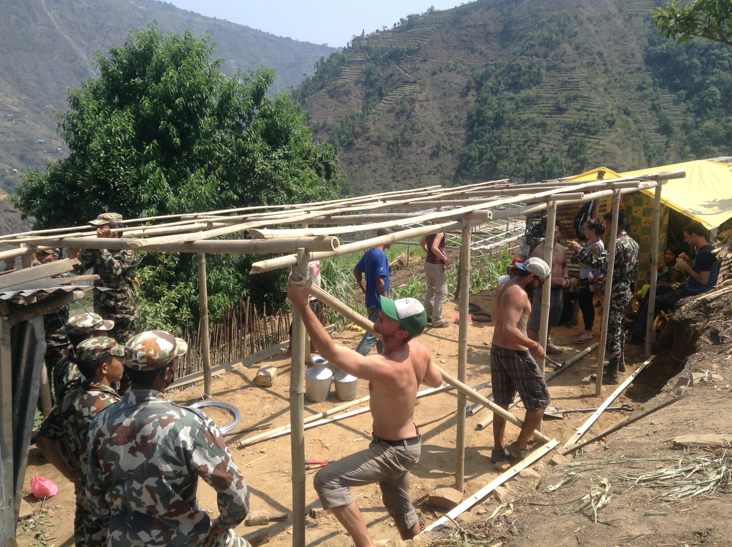 Sean, Ben, and locals constructing a bamboo frame