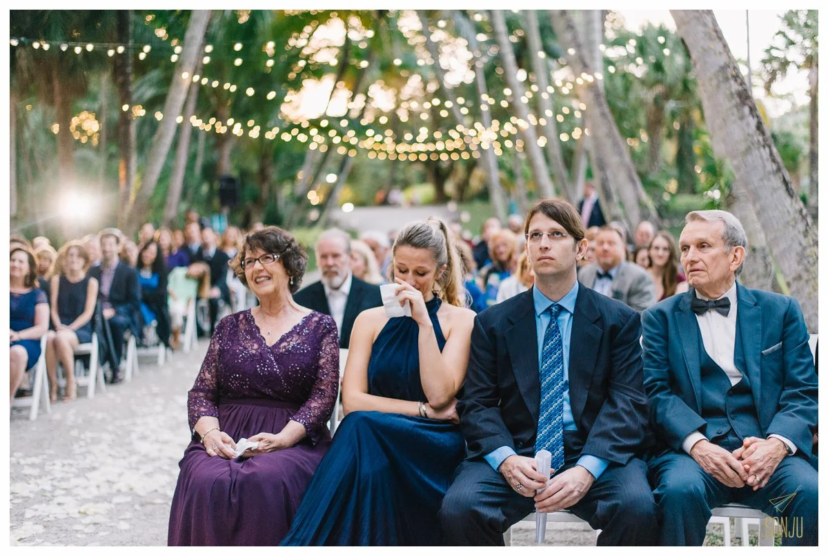 Guests get emotional during a wedding ceremony at the Bonnet House in Fort Lauderdale Florida 