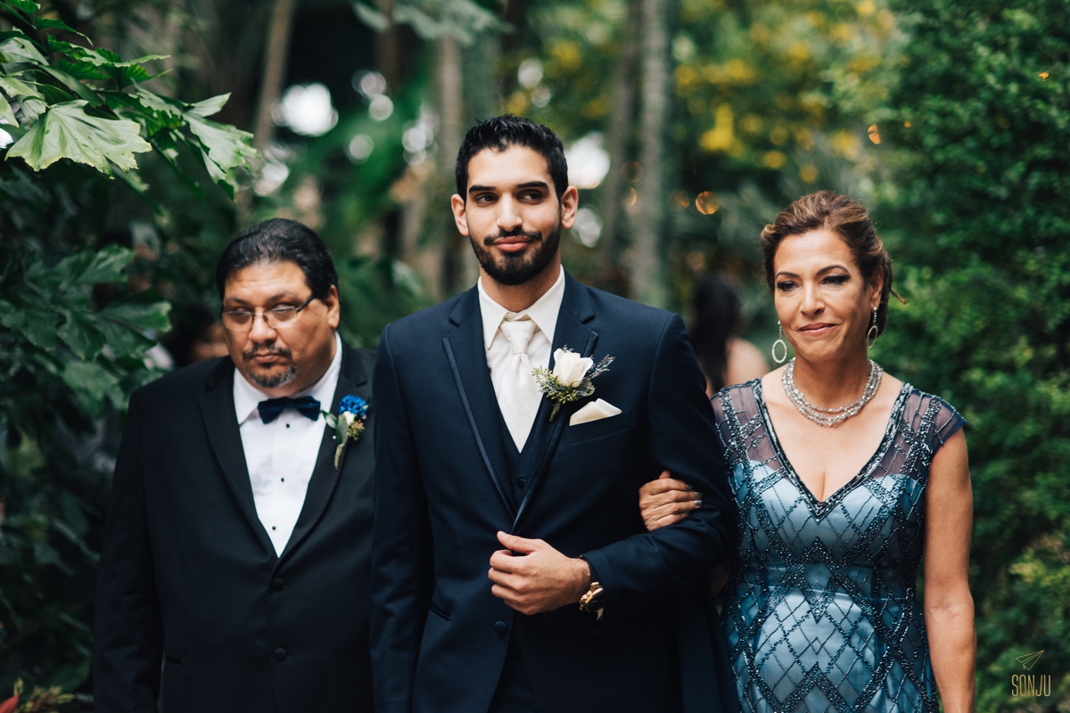 Parents walk groom down the aisle