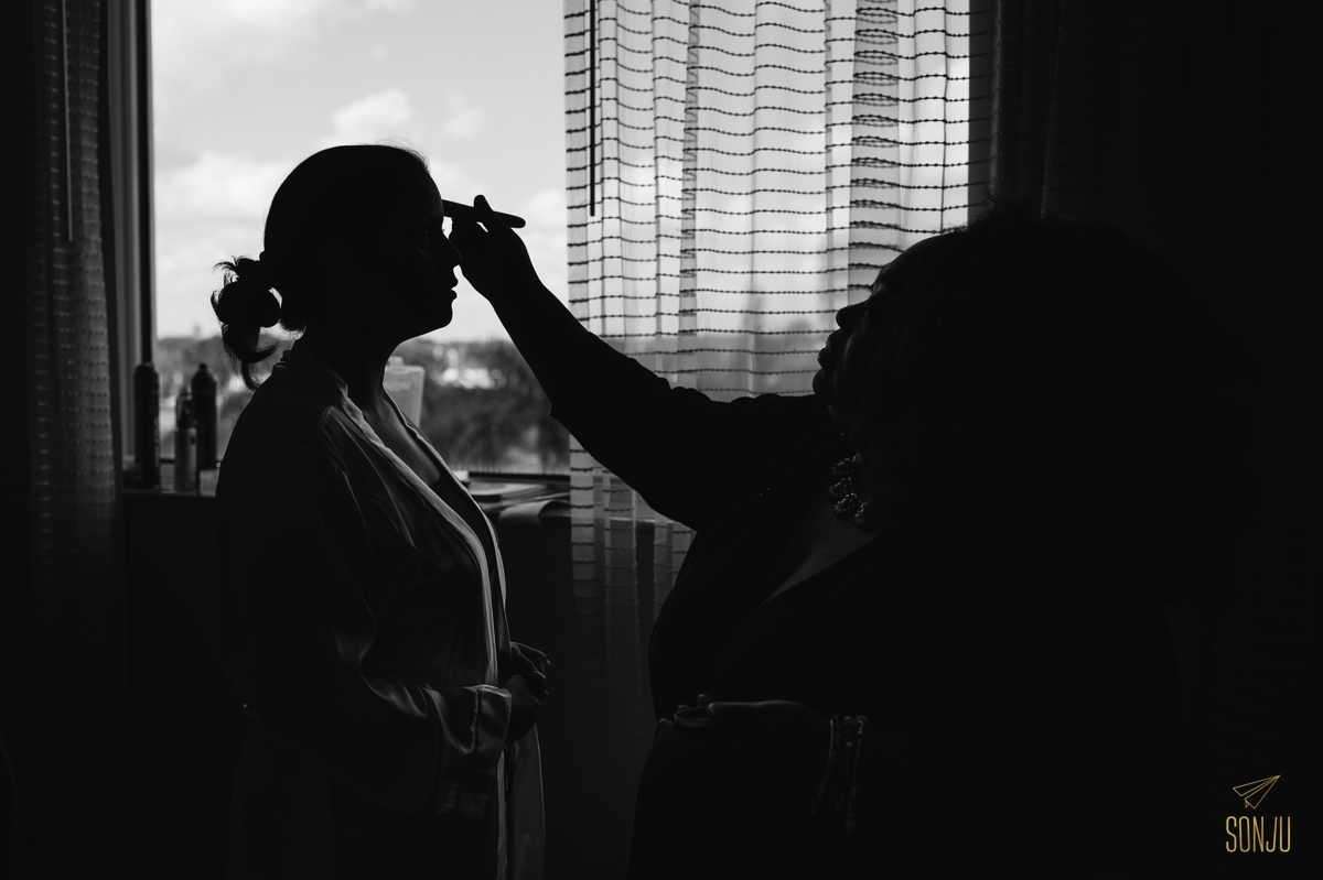South Florida Makeup Artist Toshi applying makeup to bride