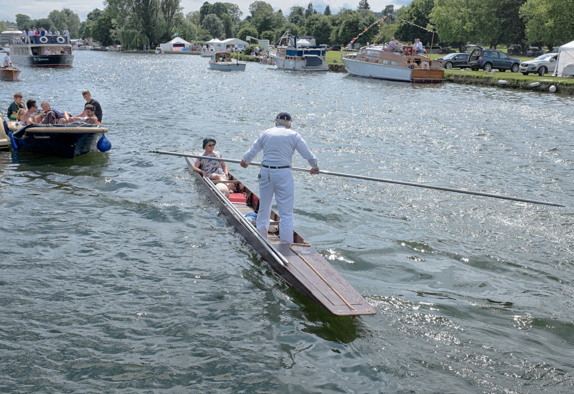  A spectator at Henley Royal Regatta takes to the water in a punt to watch the racing. Rowing boats, cruisers and bargers also plow up and down the 2.5km stretch of the river Thames to watch the events. 