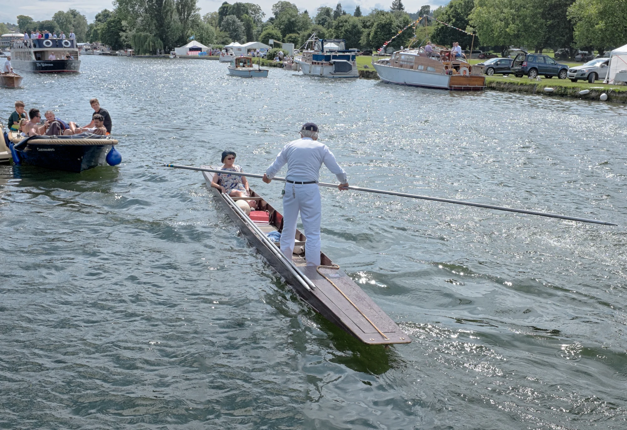 A spectator at Henley Royal Regatta takes to the water in a punt to watch the racing. Rowing boats, cruisers and bargers also plow up and down the 2.5km stretch of the river Thames to watch the events.