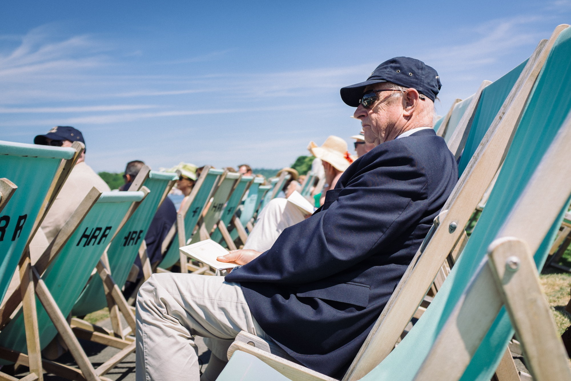  A spectator relaxes in the heat of the midday sunshine in the Steward's Enclosure at Henley Royal Regatta. Men are not allowed to take off their jackets, despite the temperature, unless a special announcement is made by officials. 