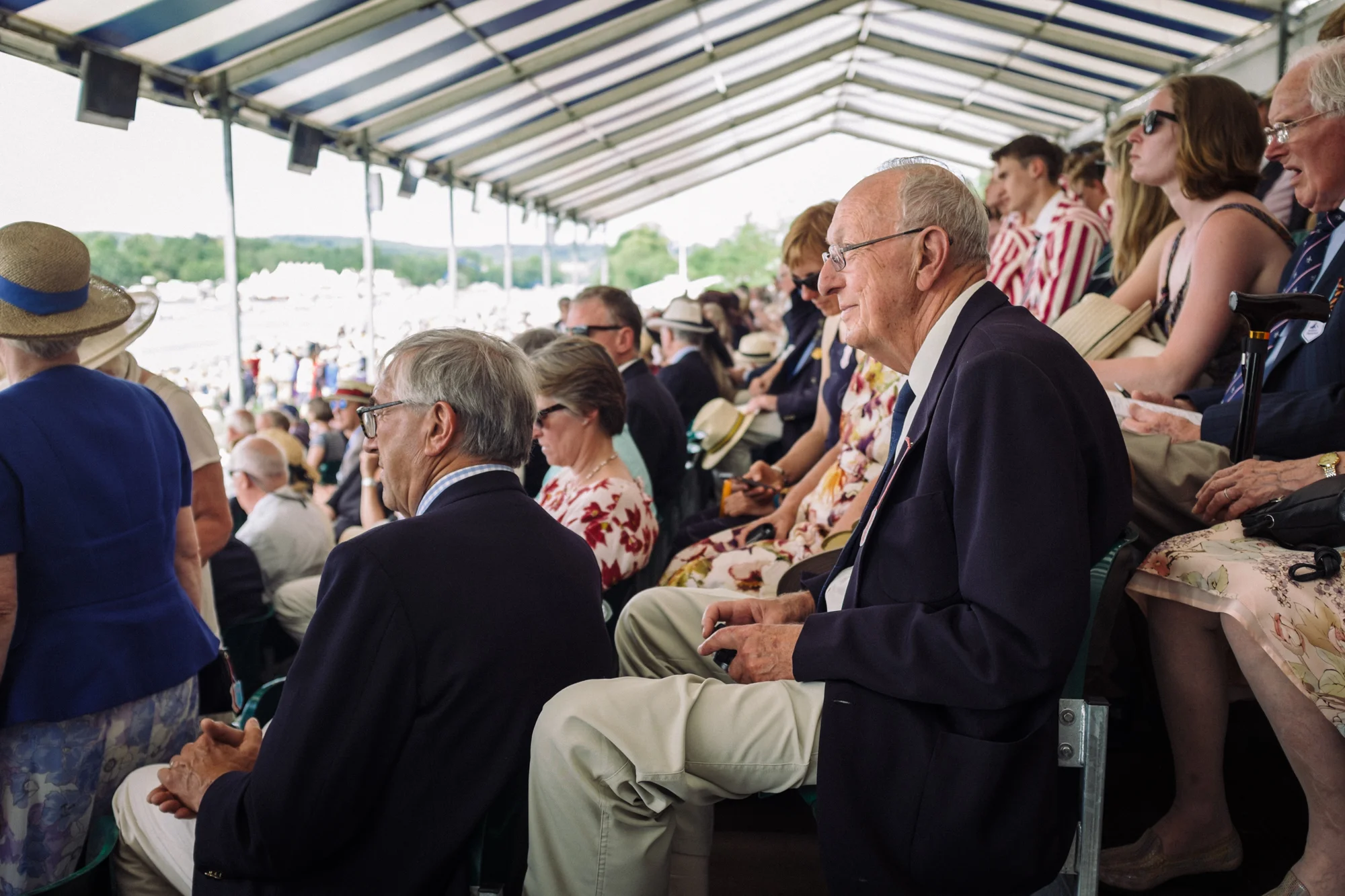 A spectator at Henley Royal Regatta enjoys the view from the grandstands.