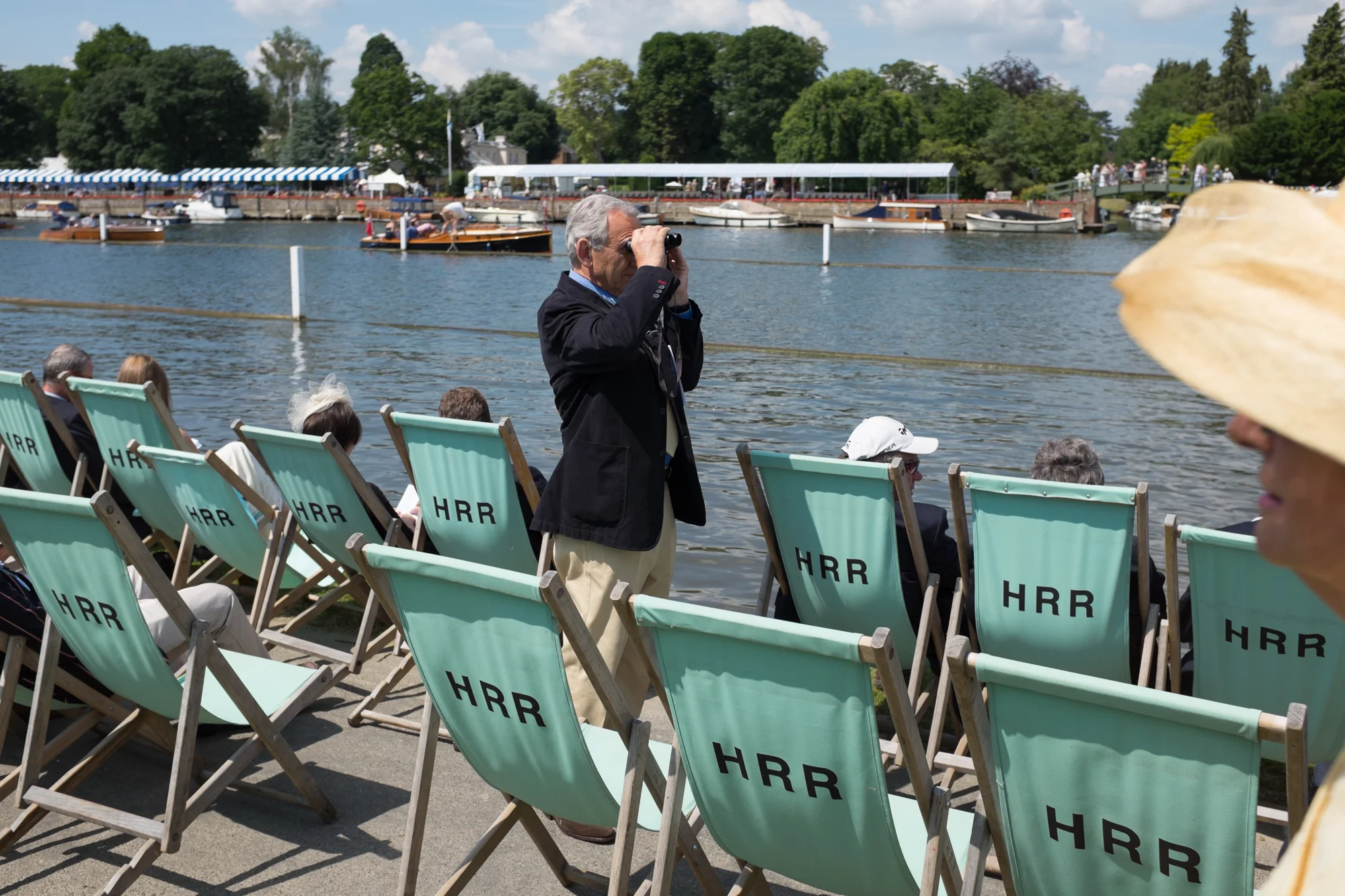 A spectator at Henley Royal Regatta surveys the course.