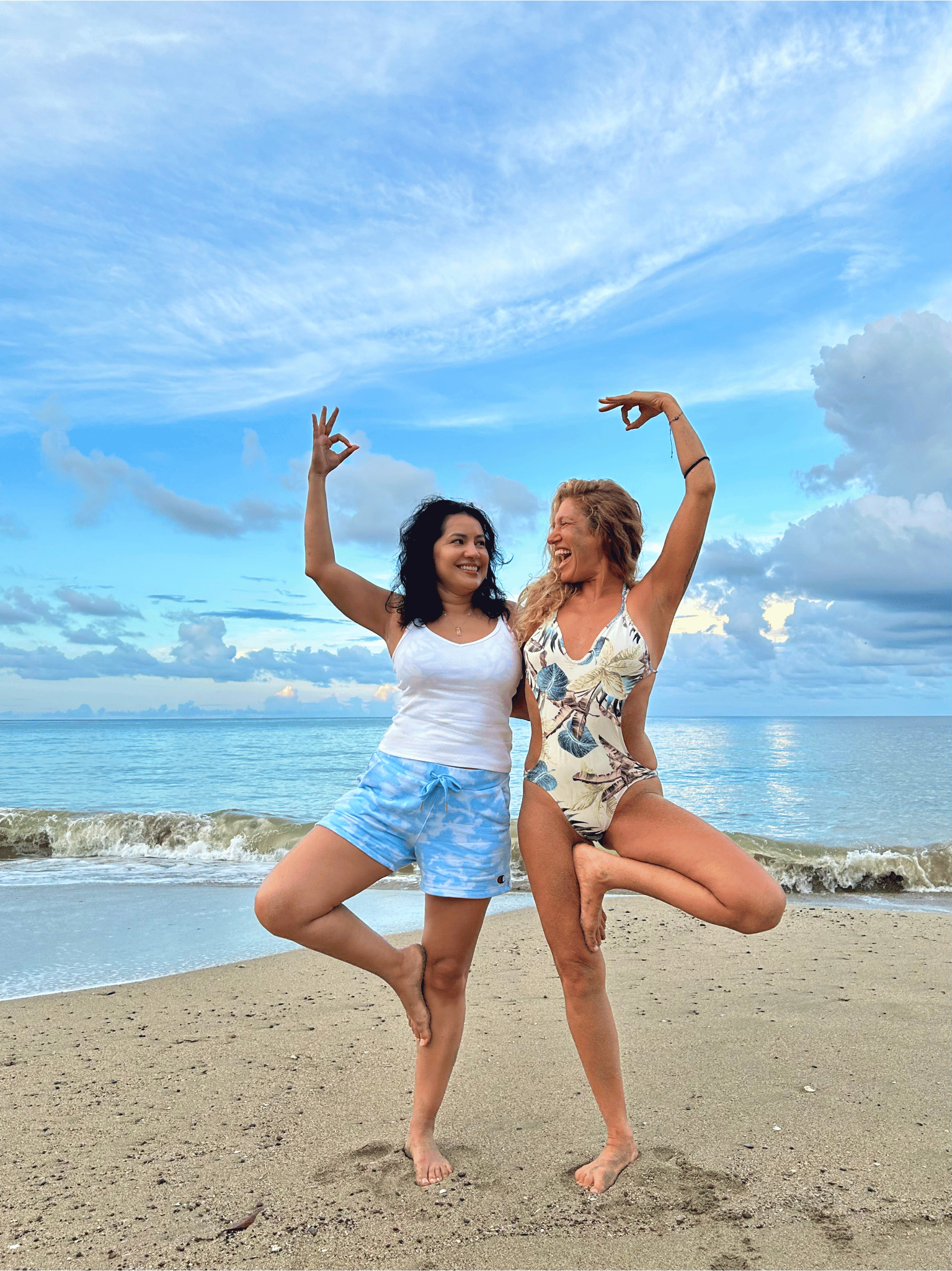 Pure Bliss Retreats - Fern Olivia and guest practicing yoga on the beach