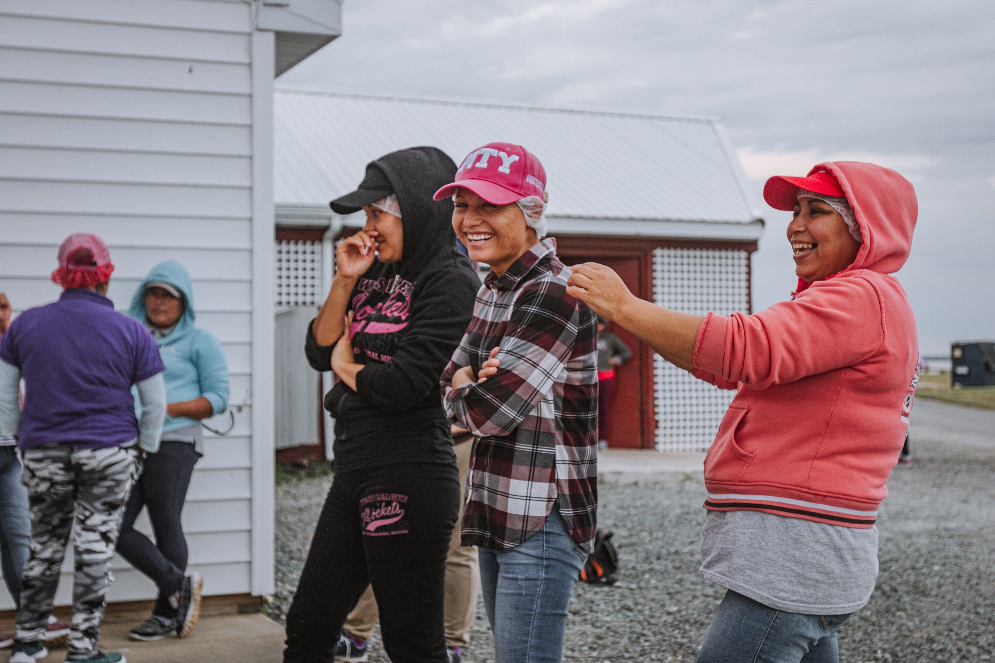  A group of workers during the day shift hang outside the processing plant as their lunch break comes to an end. The seasonal workers are among about 400 who arrive on Maryland’s Eastern Shore nearly every year, mostly from Mexico. They endure months