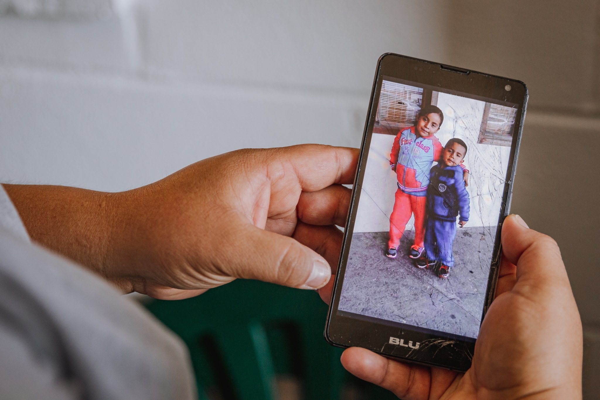  Melva Guadalupe Vázquez, 28, of Ciudad del Maíz, shows a photo of her children before her next shift at Lindy’s Seafood. “I hope my kids understand one day why I do this,” Vazquez said, “and why I have to be away.” 