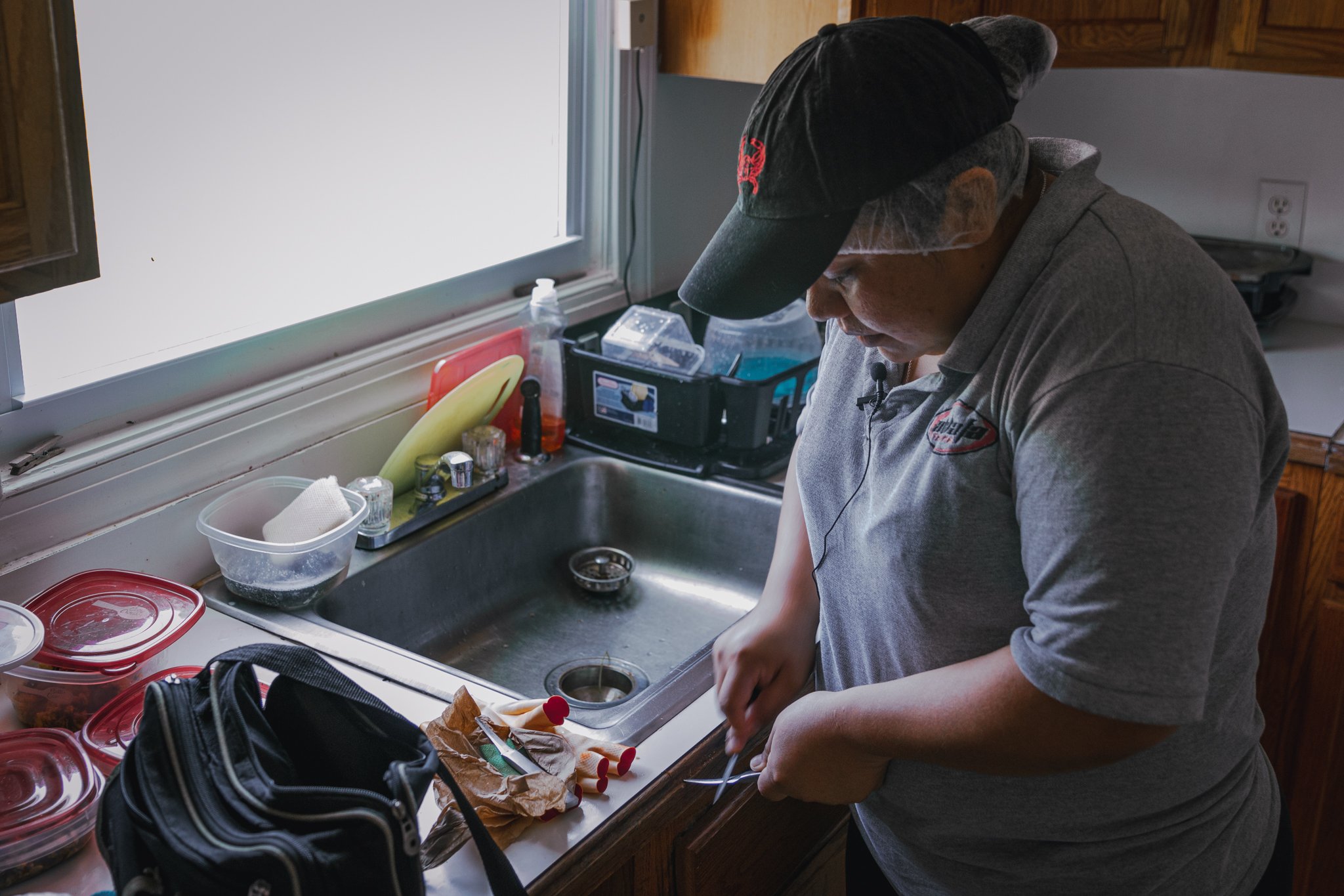  Melva Guadalupe Vázquez, 28, of Ciudad del Maíz, in San Luis Potosí, Mexico packs a lunch, a pair of gloves and sharpens two small crab picking knives before another shift at Lindys Seafood. “I do not accept or agree with the ideals of the presid