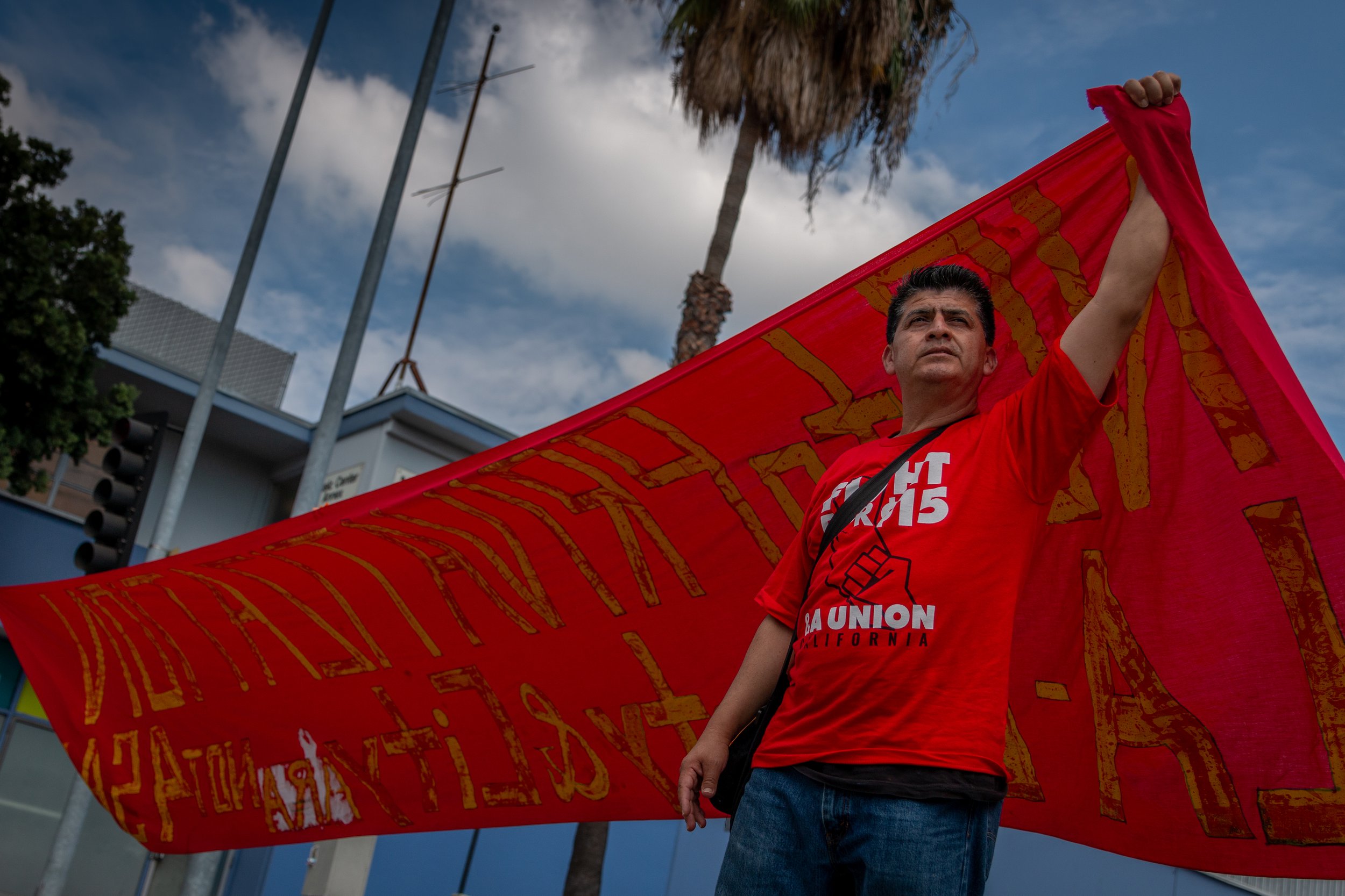  Adan Robles, who works three jobs and is a member of three unions, stands tall as he marches down Cesar Chavez Avenue in Downtown Los Angeles during the “Together we Rise and Resist” march and rally to defend workers’ rights and protections on Labor