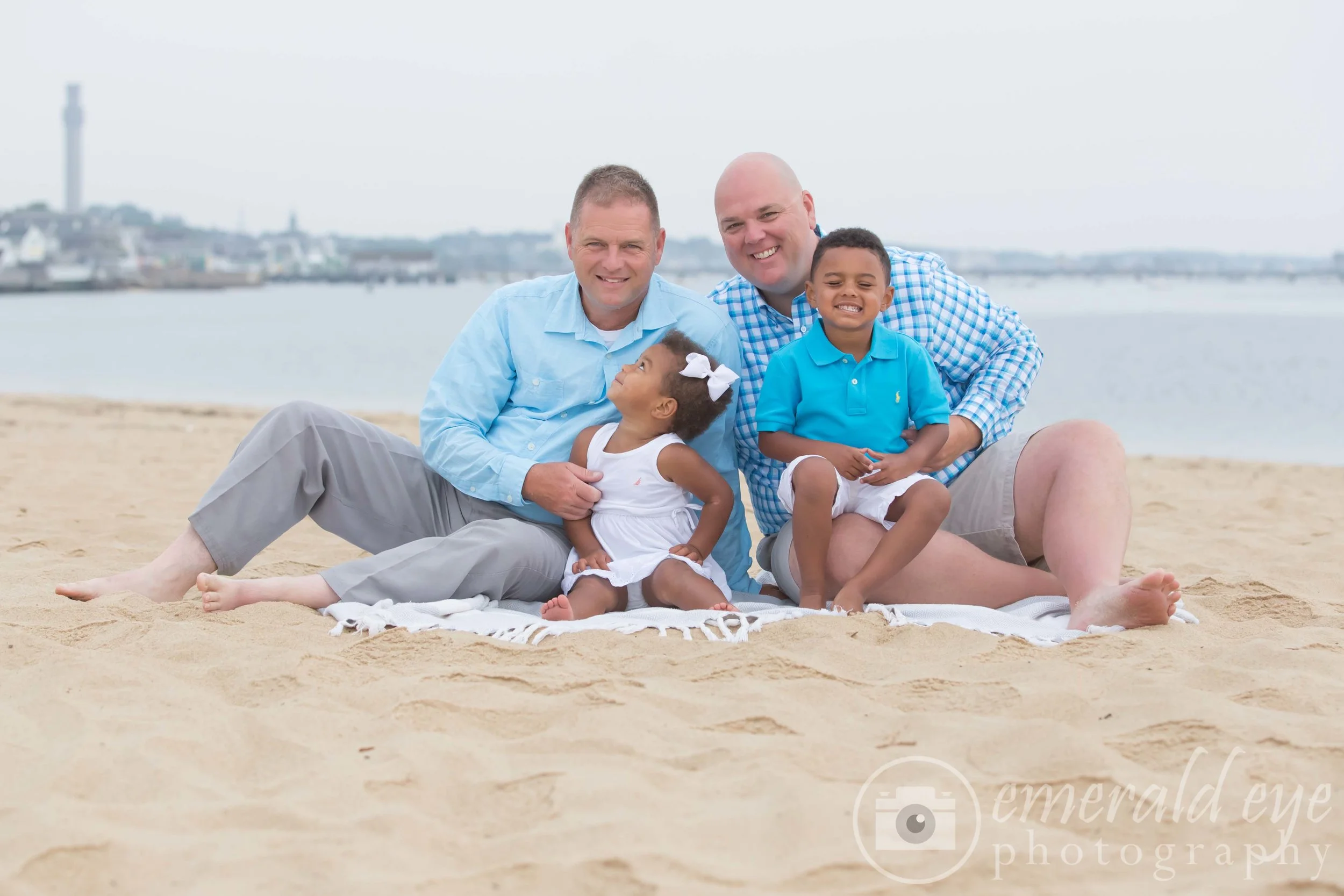 Dads and siblings playing on the beach in Provincetown