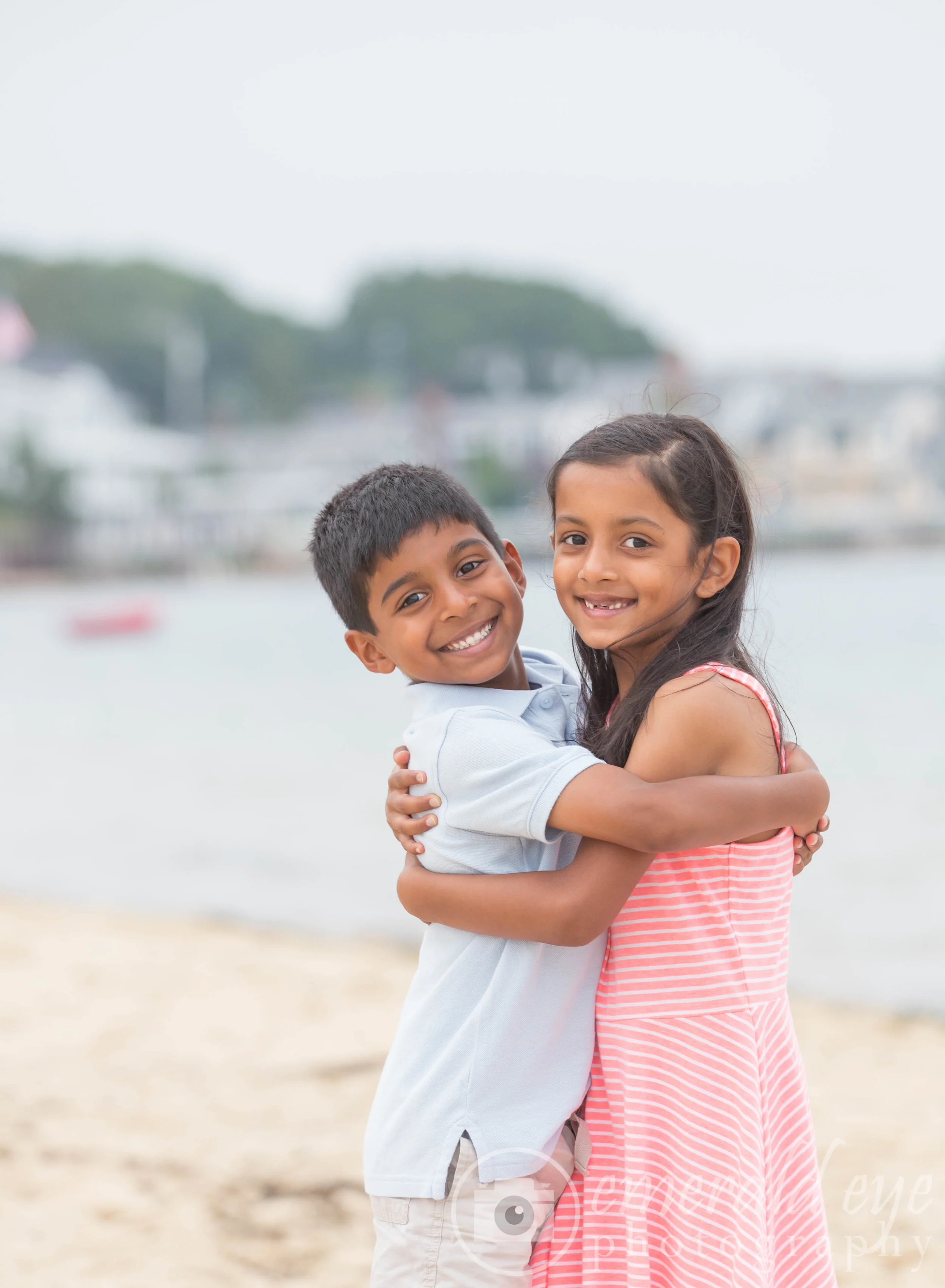 Brother and sister hugging on a Provincetown beach during Family Week