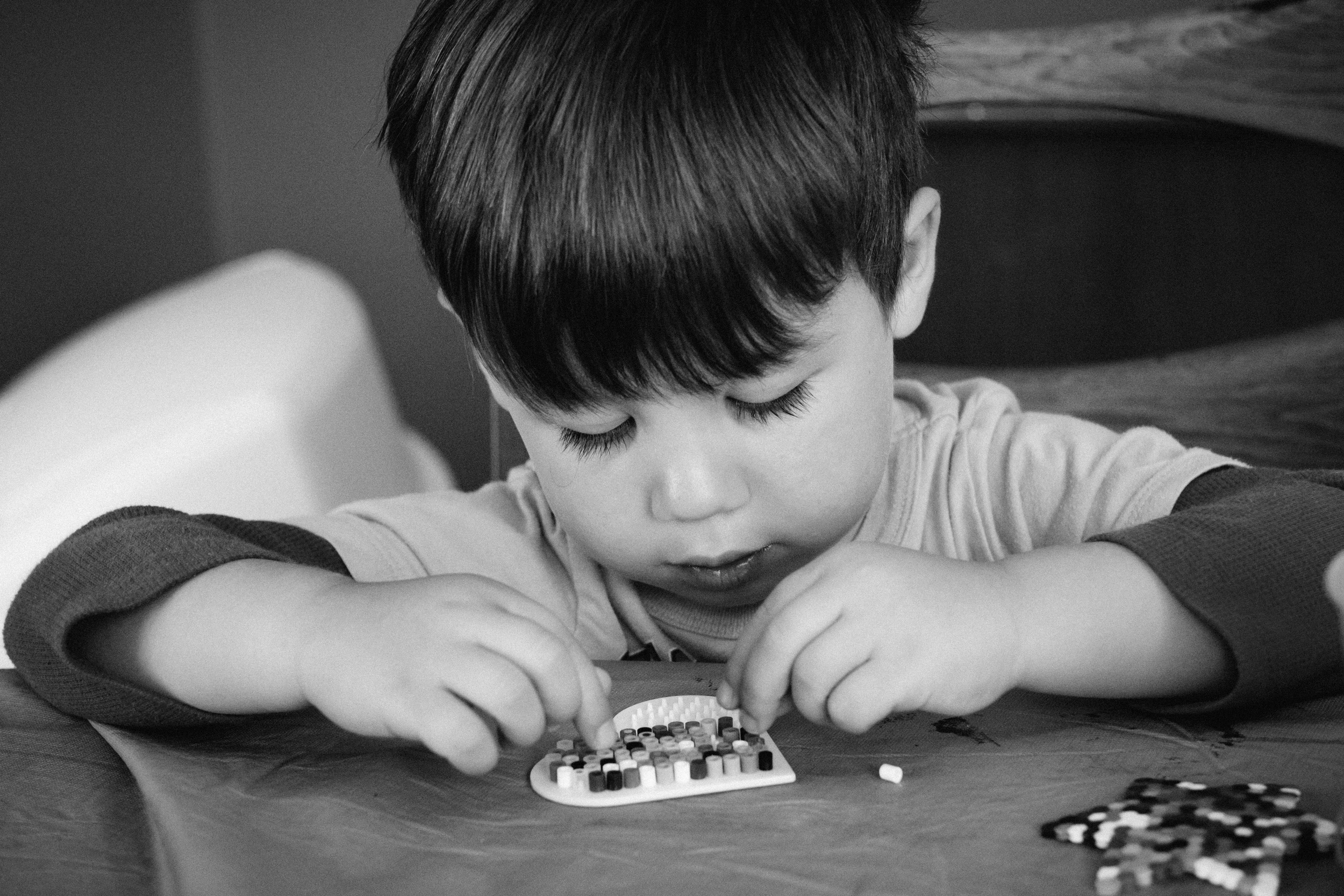 Focusing on his perler beads. 