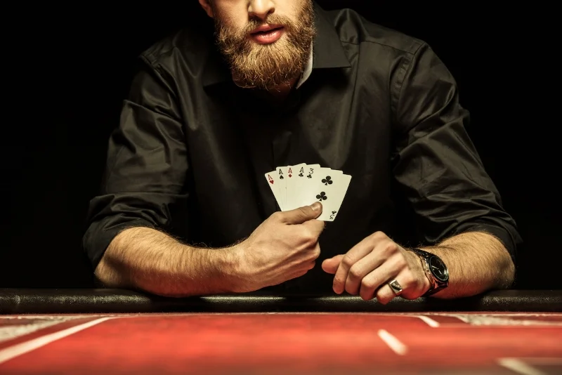 Cropped-shot-of-bearded-man-showing-poker-cards (Sized).jpg