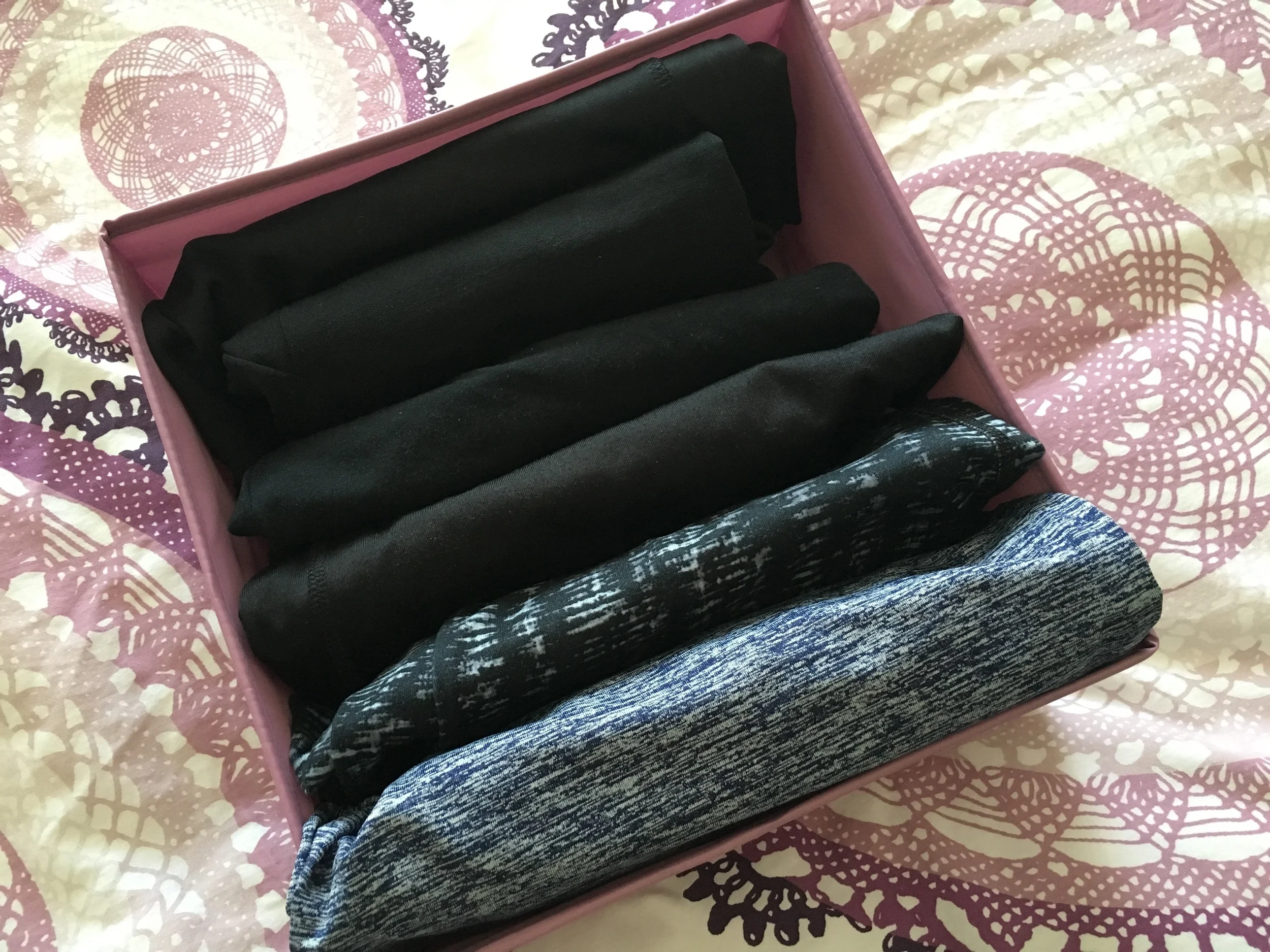 Here's an example of leggings folded upright. Use boxes/bins like this to separate by length (full length vs cropped/capri leggings), which saves you time getting ready!