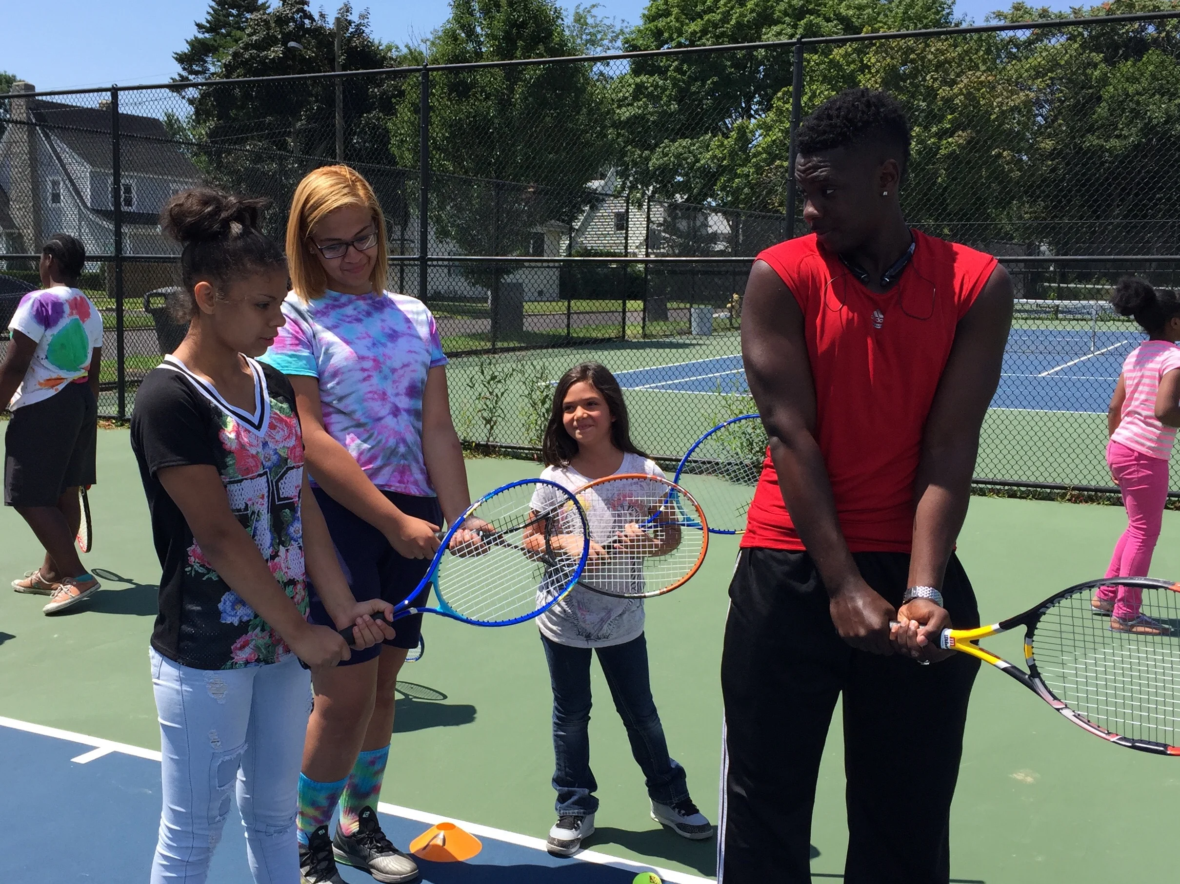 First Serve Bridgeport alum now helping new team members with their strokes.