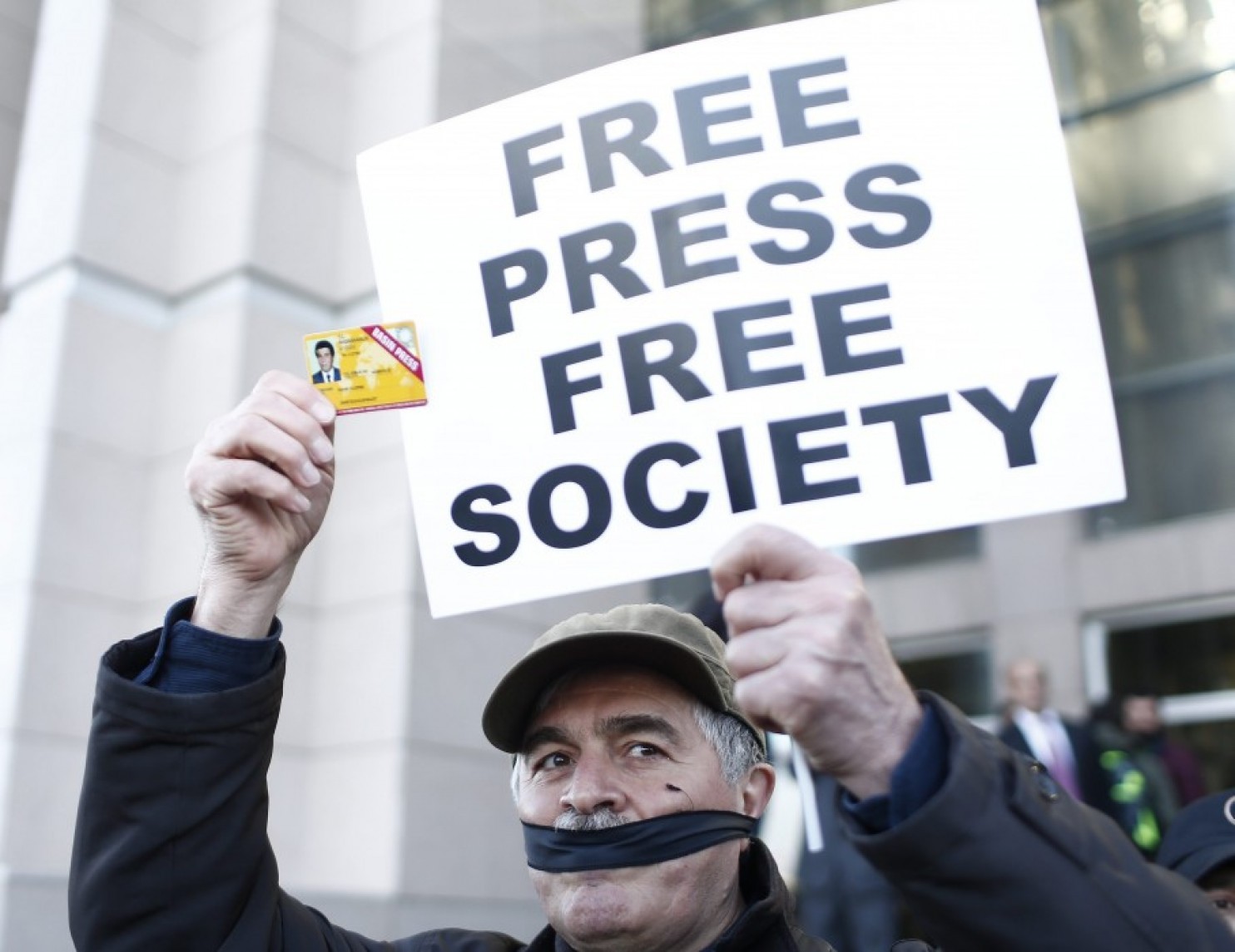 A Turkish protester holds a placard and a press card on April 1 before the trial of two journalists. Turkey ranks 151 out of 180 countries in terms of press freedom. (Sedat Suna/European Pressphoto Agency)