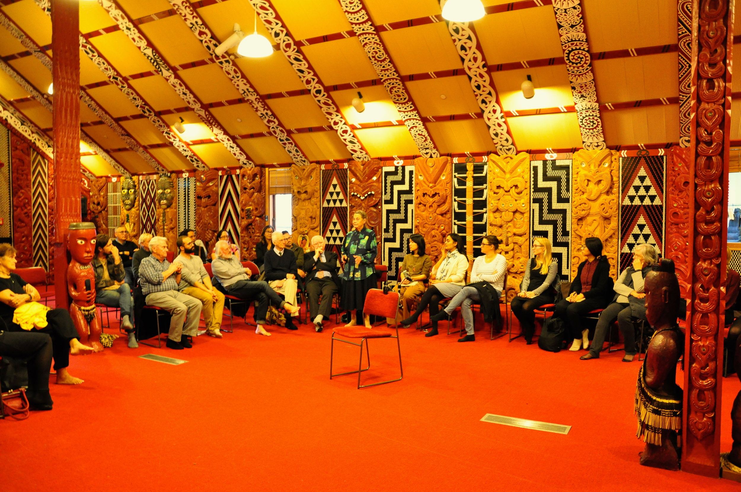 Dame Dr. Joan Metge (standing) during the marae kōrero at Te Tumu Herenga Waka. Bernie Kernott is seated to the left, and Te Range Hīroa is to the far left.