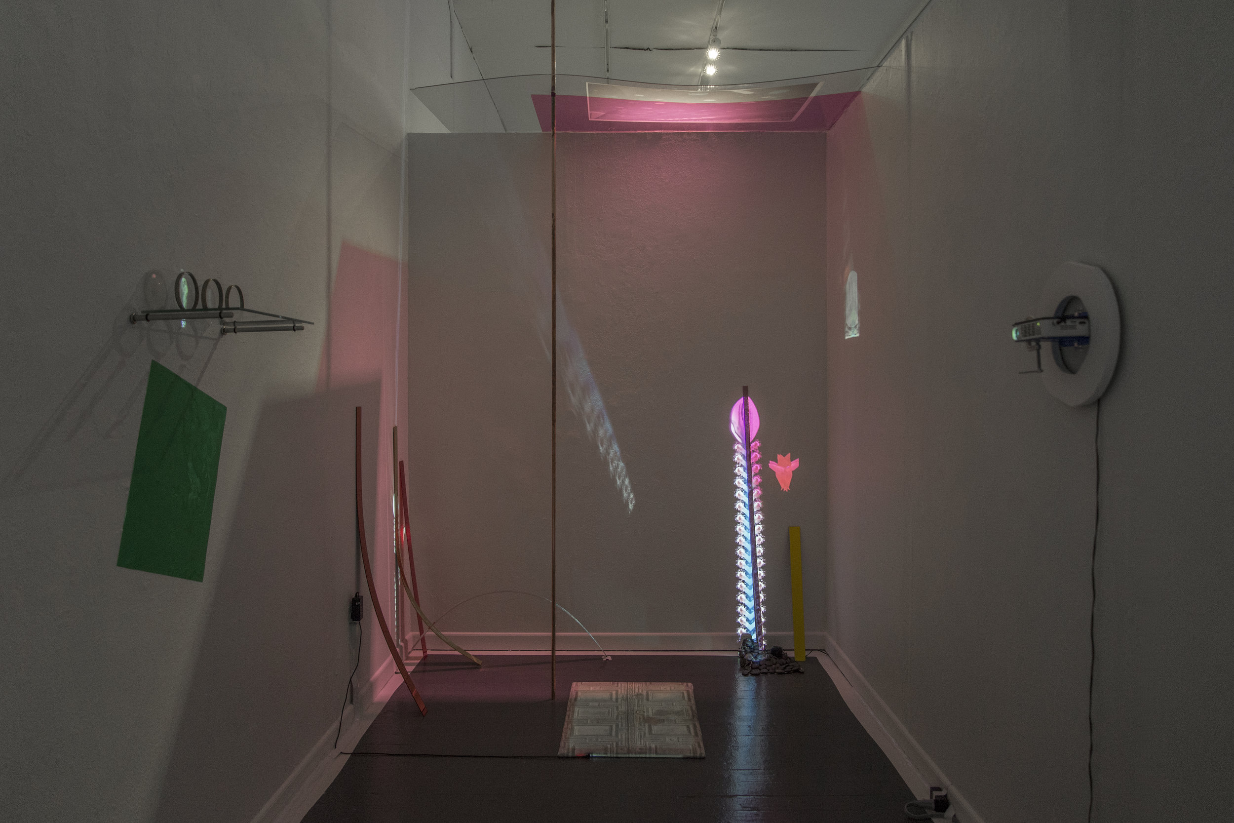 My Ghost of your Grandmother's Beach-House, 2015, HD video, projector, plastic stand, painted wood, clamp, 3 glasses, glass shelf, brackets, drawing on plastic, plastic film, flashlight, copper rod, light pad, inkjet print of fabric, inkjet print on…